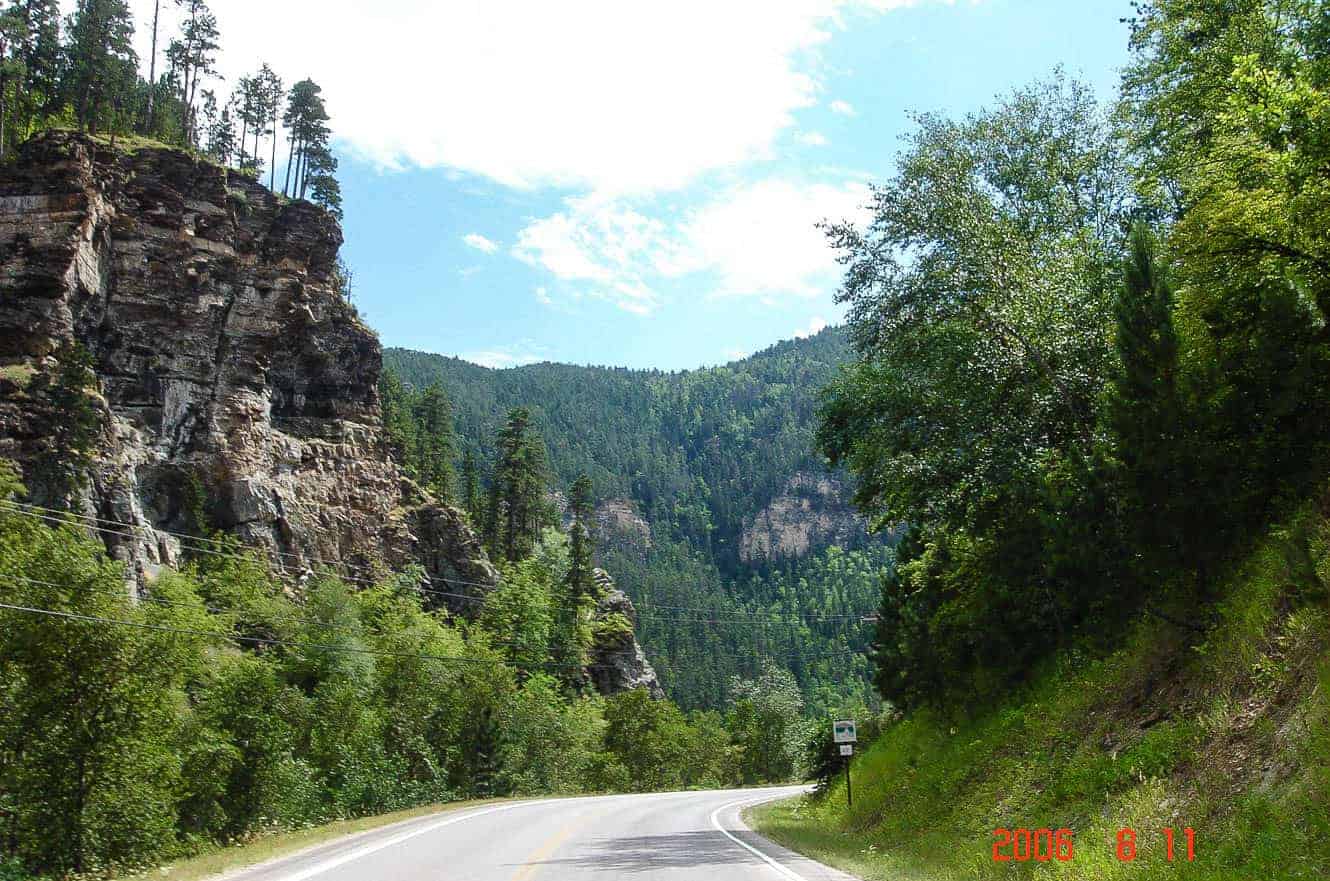A winding forested road through a rock canyon on the Spearfish, Deadwood, and Lead loop