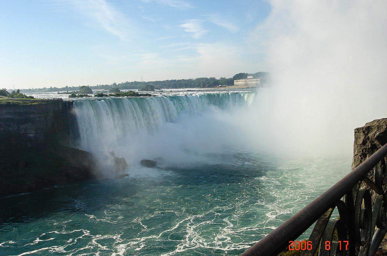 A view along the Niagara River gorge toward the falls, with hotels and a bridge in the distance