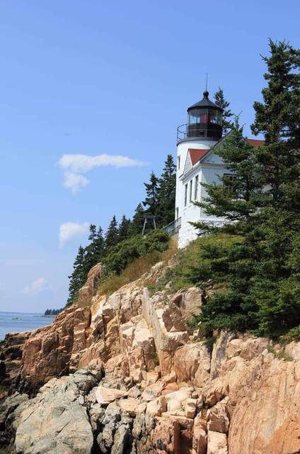 The Bass Harbor Head Lighthouse rising above the rocky, pink granite cliffs