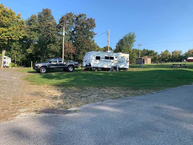 The truck and RV parked at the campsite at Pleasant Acres Farm RV Resort