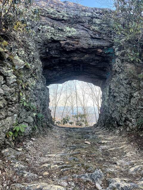 Looking through the Hole in the Wall rock arch on the trail