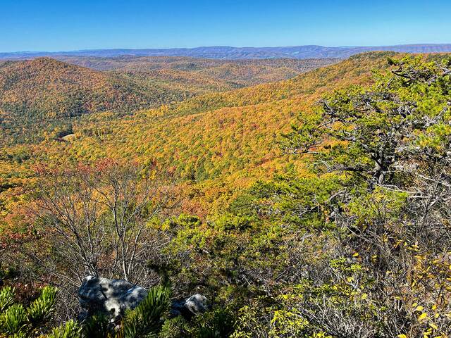 Rocky outcrops overlooking rolling ridges in fall color