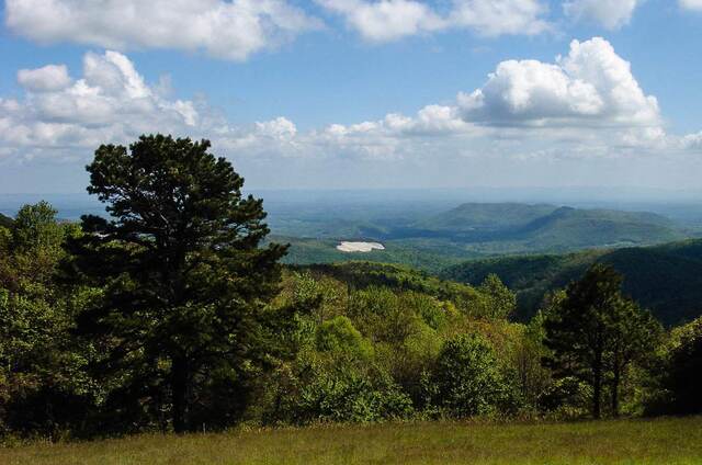 The Devils Garden Overlook sign on the Blue Ridge Parkway, with layered green mountains stretching into the distance