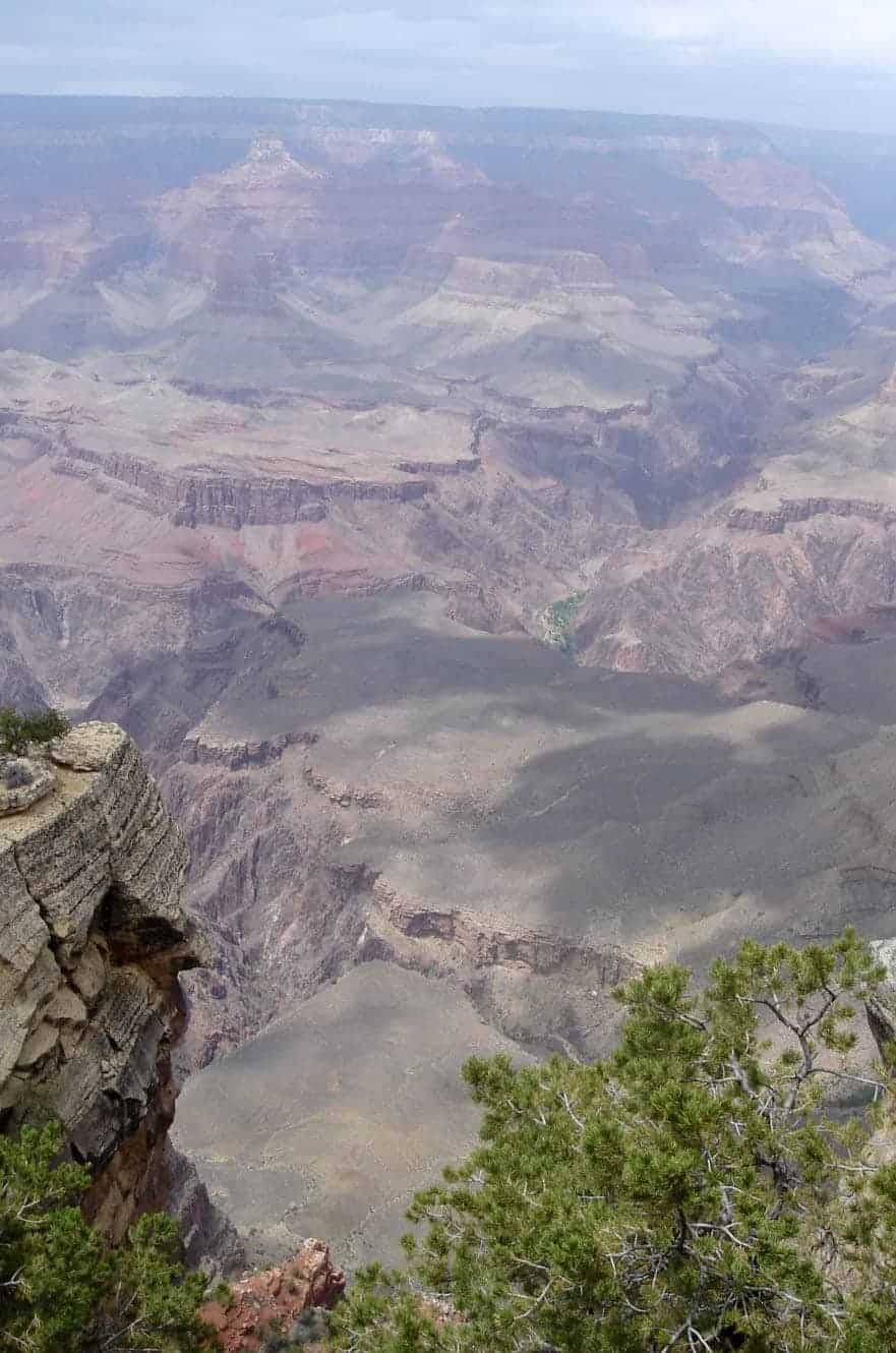 Layered red and tan rock formations descending into the depths of the Grand Canyon