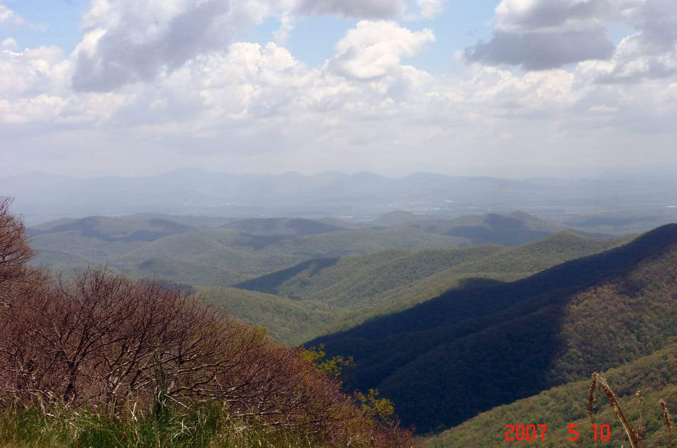 Sunlit and shadowed ridgelines rolling across the Blue Ridge Mountains